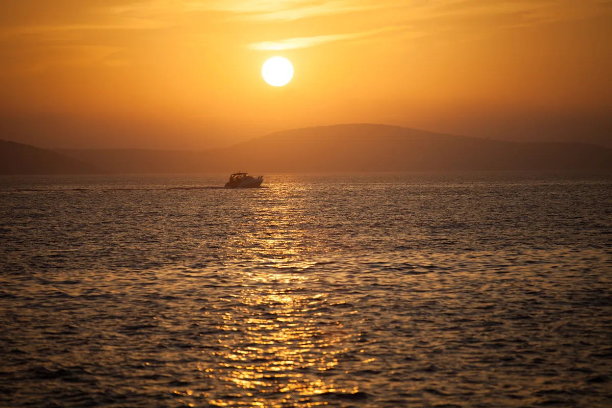 A boat on the Adriatic among the Dalmatian islands at sunset